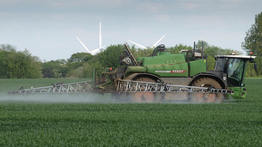 Fertiliser being sprayed by a tractor